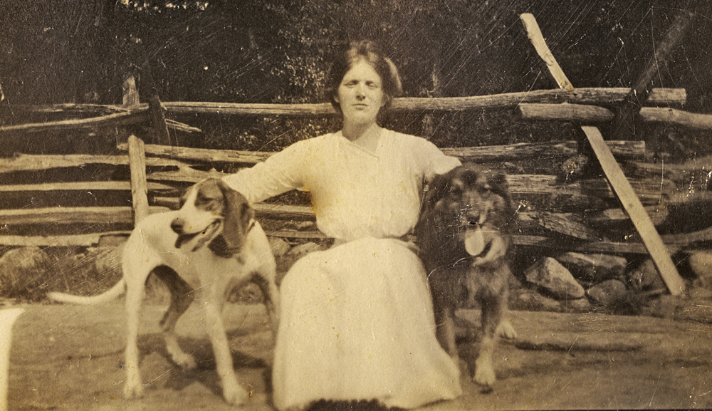 Photo of a young Lucy Seger with hounds